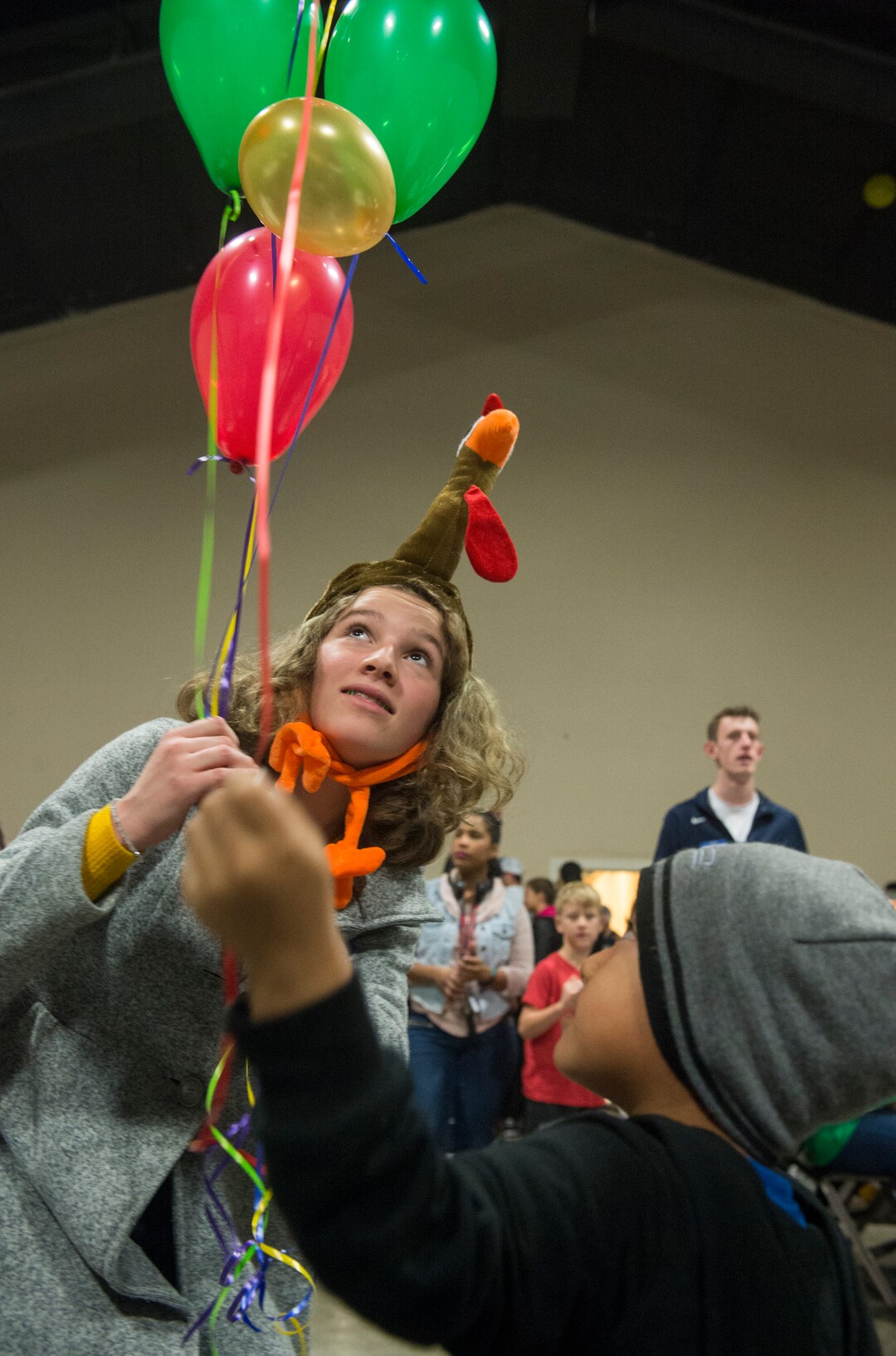(Rick Egan  |  The Salt Lake Tribune)     A volunteer named Flannery hands out balloons to kids at the 25th Annual Thanksgiving Dinner for the hungry and homeless at the Christian Life Center on Redwood Road in Salt Lake City, Wednesday, Nov. 21, 2018.