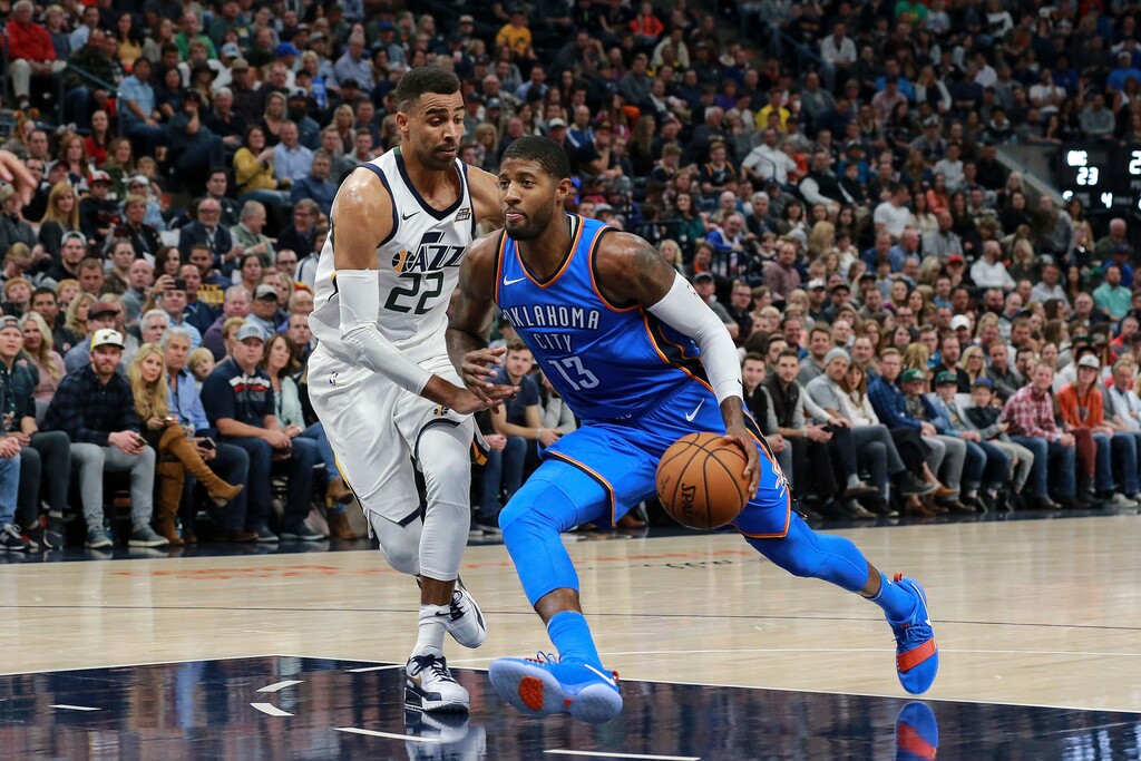 Utah Jazz forward Thabo Sefolosha (22) tries to stop Oklahoma City Thunder forward Paul George (13) during the second quarter of an NBA basketball game Saturday, Oct. 21, 2017, in Salt Lake City. (AP Photo/Chris Nicoll)