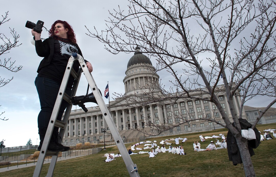 (Scott Sommerdorf   |  The Salt Lake Tribune)   Artist Cat Palmer makes photos of protesters dressed in white jumpsuits who spelled out "GO HOME TRUMP" on the south lawn of the Utah State Capitol, Sunday, December 3, 2017, during a protest organized by artist Cat Palmer ahead of Trump's visit Monday. When asked why she organized the event she said:"Because Senator Dabakis called me and told me too!We don't have somebody representing our voices right now, right? Thats a problem. Sometimes when we feel helpless we make art hoping our voices will be heard. It's an outlet for people.It's therapeutic, .... because we are feeling lost right now."