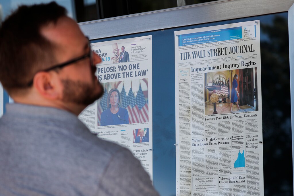 (Pablo Martinez Monsivais | AP) A man stops to look at newspaper front pages, from around the US, on display at the Newseum in Washington, Wednesday, Sept. 25, 2019.