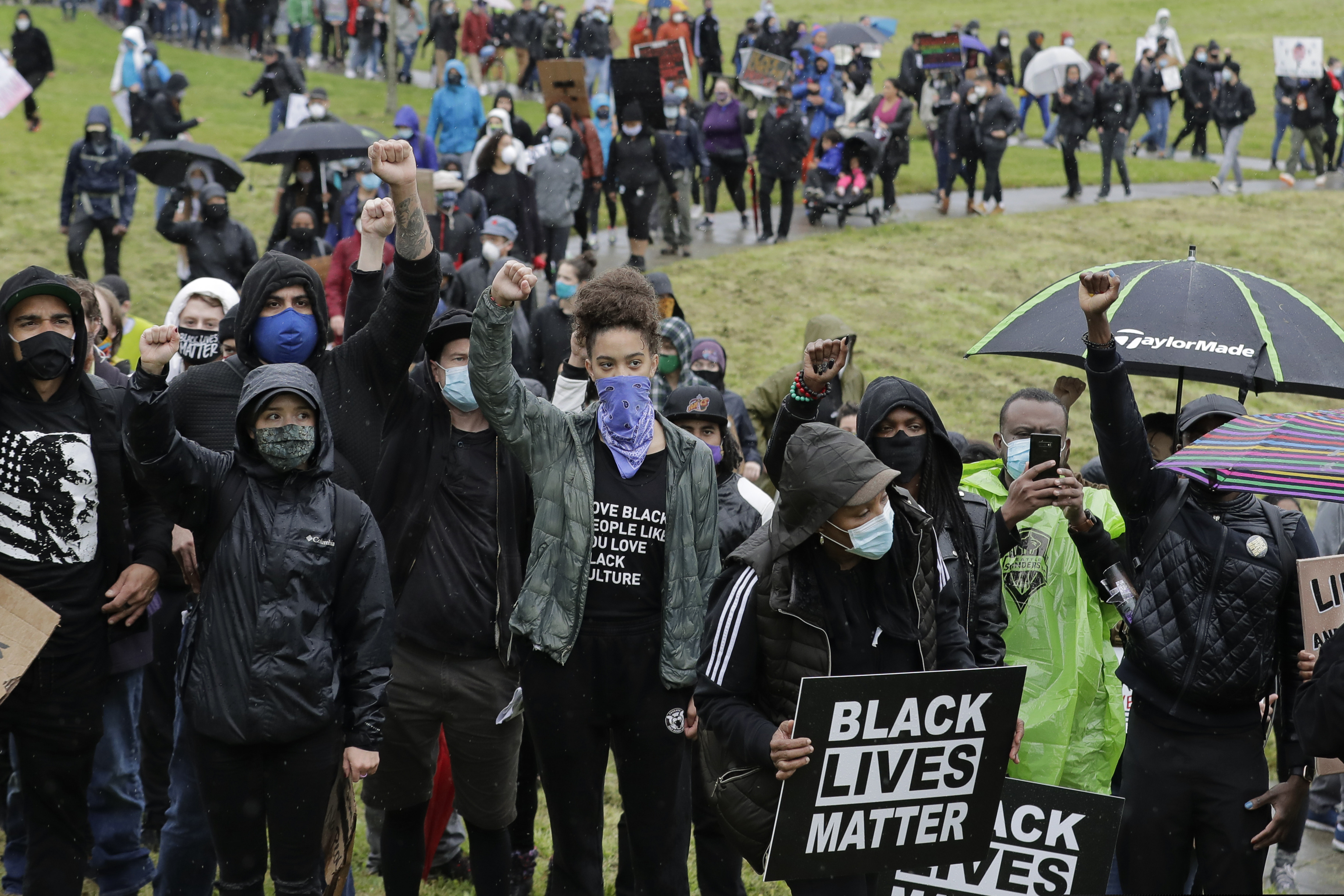 (Ted S. Warren | AP file photo)  Protesters raise their fists as they take part in a rally that followed a "Silent March" against racial inequality and police brutality that was organized by Black Lives Matter Seattle-King County, Friday, June 12, 2020, in Seattle. People marched for nearly two miles to support Black lives, oppose racism and to call for police reforms among other issues.