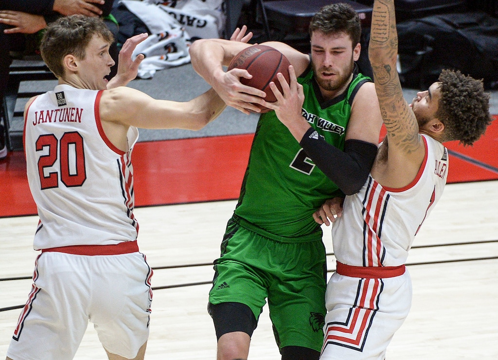 (Leah Hogsten | The Salt Lake Tribune) Utah Valley Wolverines forward Evan Cole (2) is pressured by Utah Utes forward Mikael Jantunen (20) and Utah Utes forward Timmy Allen (1) as the Utes host Utah Valley University on Tuesday, Dec. 15, 2020 at the Jon M. Huntsman Center. The Utes won 75-67.
