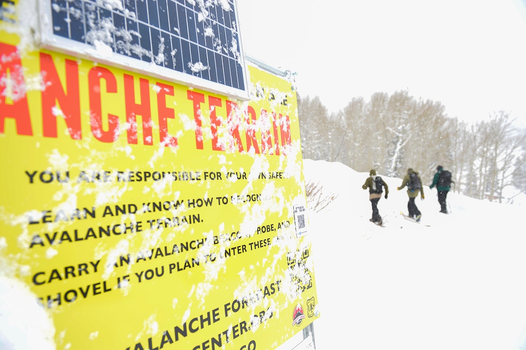 (Chris Samuels | The Salt Lake Tribune) Backcountry riders pass an avalanche warning sign at Grizzly Gulch in Alta, Wednesday, Nov. 9, 2022, as heavy preseason snowfall falls on the Wasatch Front. Avalanche conditions in the Uinta mountains, where skier died in a slide Thursday, differ greatly from those in the Wasatch.