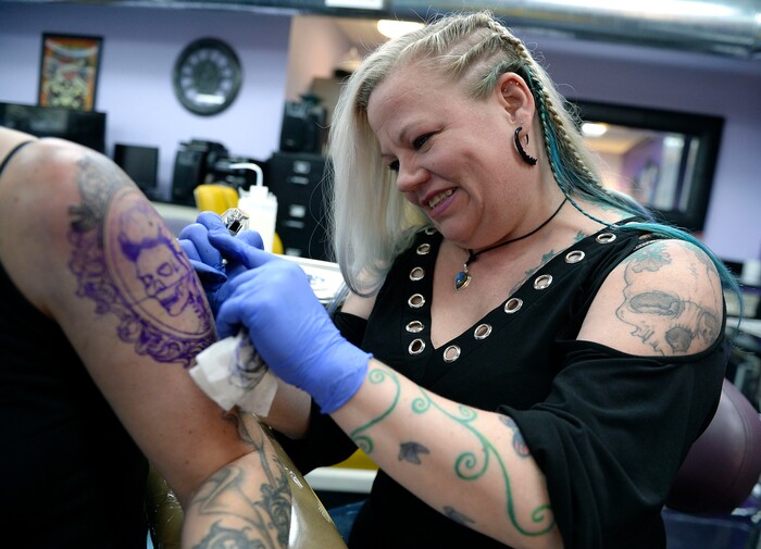 (Al Hartmann  |  The Salt Lake Tribune) 	
Terrina Francis, tatoo artist and owner of Fallen Angel Tattoo, is Salt Lake's only all-women tattoo studio.  She works on a personal tattoo for Shannon Gibbs.   The design is an old-fashioned cameo skull that she has thought about and wanted for four years.   Francis also offers to tattoo over scars and disfigurements due to domestic violence, breast cancer, and burns.   The shop offers a place where women can feel comfortable about getting tattooed in a very male-dominated field. 