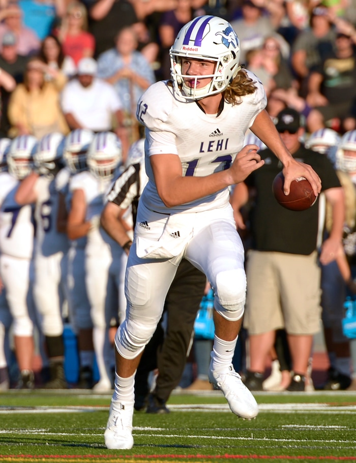 (Leah Hogsten  |  The Salt Lake Tribune) Lehi's quarterback Cammon Cooper looks for the pass. Lehi High School leads Alta High School 35-21 at the half during their game, Friday, August 18, 2017 in Sandy. 