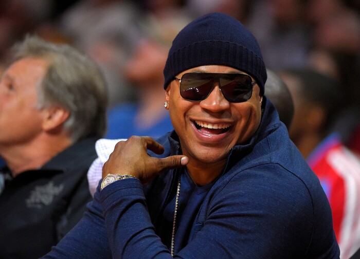 FILE - In this Nov. 3, 2014 file photo, rapper/actor LL Cool J watches the Los Angeles Clippers play the Utah Jazz during the first half of an NBA basketball game, in Los Angeles. The John F. Kennedy Center for the Performing Arts announced the recipients of the 2017 Kennedy Center Honors. They are: hip-hop artist LL Cool J, singers Gloria Estefan and Lionel Richie, television writer and producer Norman Lear and dancer Carmen de Lavallade. It’s the 40th year of the awards, which honor people who have influenced American culture through the arts. (AP Photo/Mark J. Terrill, File)
