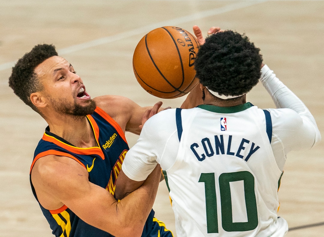 (Rick Egan | The Salt Lake Tribune) Golden State Warriors guard Stephen Curry (30) manages to score and draw a foul as he collides with Utah Jazz guard Mike Conley (10), in NBA action between the Utah Jazz and the Golden State Warriors at Vivint Arena, on  Saturday, Jan. 23, 2021.