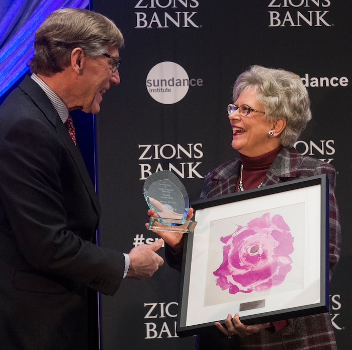 (Rick Egan  |  The Salt Lake Tribune)     Patricia Morton, dean of the University of Utah School of Nursing, receives a leadership award from Scott Anderson, president and CEO of Zions Bank, at the 2018 Sundance Film Festival Utah Women’s Leadership Celebration in Park City on Thursday, Jan. 25, 2018.