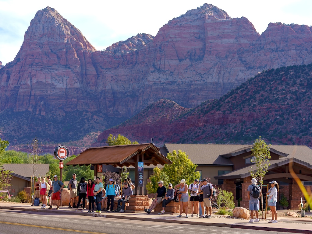 (Leah Hogsten | The Salt Lake Tribune) Mornings in Springdale, just outside the entrance to Zion National Park are a flurry of activity as hikers rush to board city shuttles to take them into the park, Sept. 26, 2021. Springdale, population 529, sees about 16,000 tourists a day. 