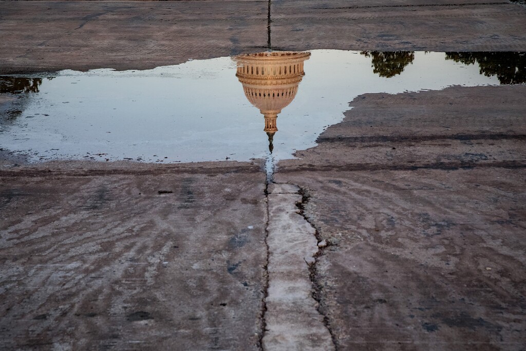 A reflection of the U.S. Capitol Building on Sept. 25, 2019. (Damon Winter/The New York Times)
