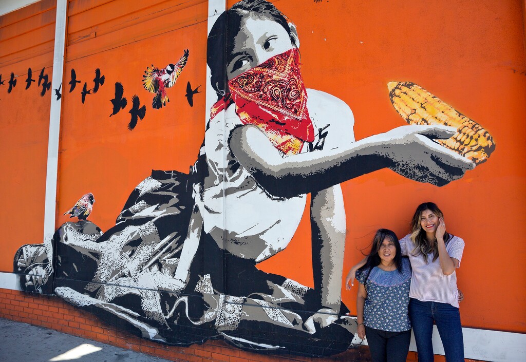 (Damian Dovarganes | The Associated Press) In this Monday, June 25, 2018, photo, Odilia Romero, a trilingual interpreter in English, Spanish and her native Zapotec, a language from the Mexican state of Oaxaca, left, and her friend Bricia Lopez pose for a photo outside her Oaxacan restaurant, La Guelaguetza in Los Angeles. Romero is working to put together interpretation teams who can help attorneys and officials communicate with non-Spanish-speaking indigenous children and their detained parents in an effort to ensure their legal, medical and other needs are met and that they understand immigration proceedings.