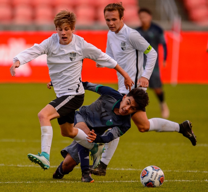 (Trent Nelson  |  The Salt Lake Tribune)  Copper Hills's Bogar Hernandez defended by Weber's Jake Youngberg as Weber faces Copper Hills High School in the 6A boys state championship game at Rio Tinto Stadium in Sandy, Thursday May 23, 2019.