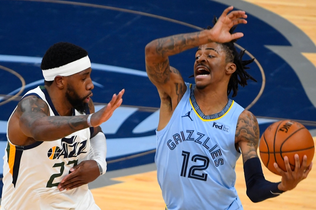 Memphis Grizzlies guard Ja Morant (12) tries to get past the defense of Utah Jazz forward Royce O'Neale during the first half of Game 3 of an NBA basketball first-round playoff series Saturday, May 29, 2021, in Memphis, Tenn. (AP Photo/John Amis)