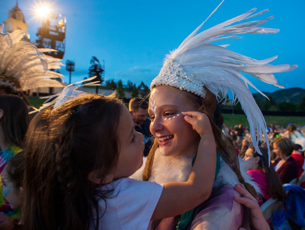 (Rick Egan  |  The Salt Lake Tribune)  Catalina Pickering, 3, from Saratoga Springs, is fascinated with the costume worn by 15-year-old, Bethany Christensen, 15, a Lamanite dancer, as the performers mix with the audience, before the Mormon Miracle Pageant Wednesday, June 12, 2019.  The final run for the pageant continues through Saturday, June 22.