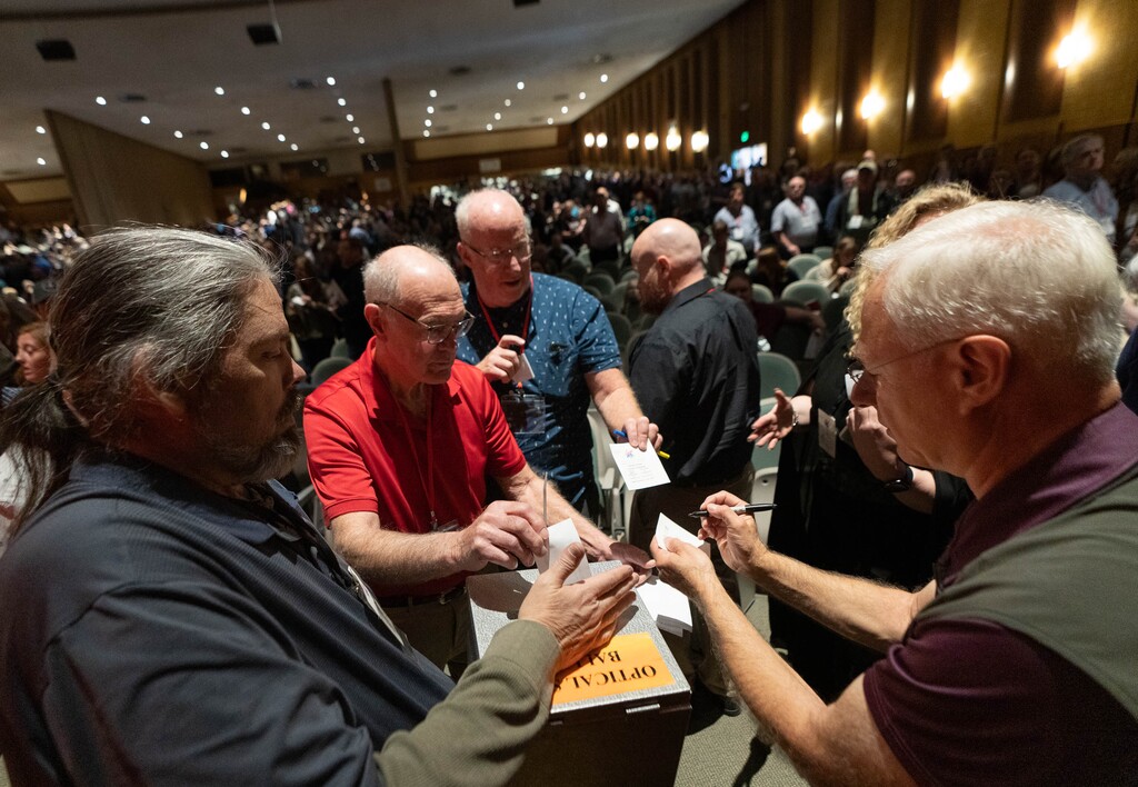 (Francisco Kjolseth | The Salt Lake Tribune) With “election integrity” driving much of the day, arising from Trump’s false claims of voter fraud, GOP delegates opt to hold the vote for Salt Lake County clerk by paper ballot as they line up to show identification and drop their vote during the Salt Lake County Republican convention at Kearns High School on Saturday, April 9, 2022.