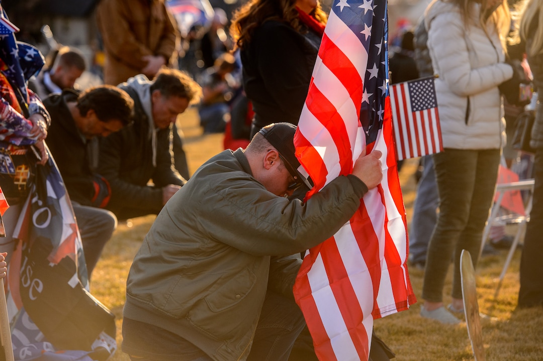 (Trent Nelson  |  The Salt Lake Tribune) Trump supporters kneel in prayer at the State Capitol in Salt Lake City on Wednesday, Jan. 6, 2021.