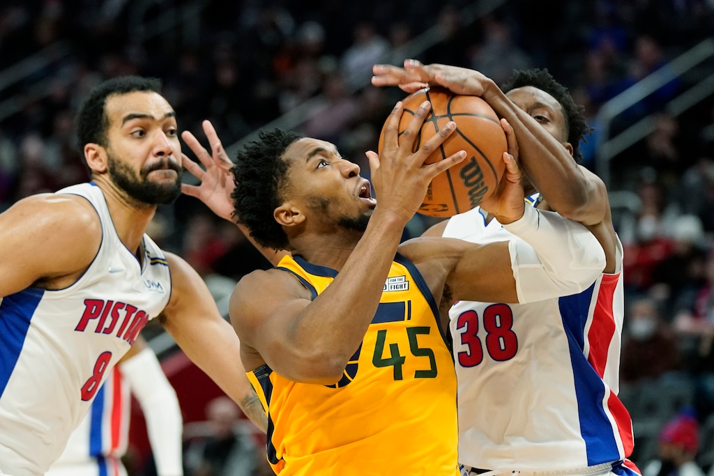 Detroit Pistons guard Saben Lee (38) blocks a shot by Utah Jazz guard Donovan Mitchell (45) during the second half of an NBA basketball game, Monday, Jan. 10, 2022, in Detroit. (AP Photo/Carlos Osorio)