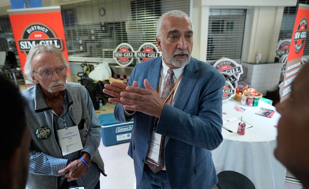 (Francisco Kjolseth | The Salt Lake Tribune) Salt Lake County District Attorney Sim Gill speaks with candidates during the Salt Lake County Democratic Party's convention at Highland High School on Saturday, April 11, 2026.
