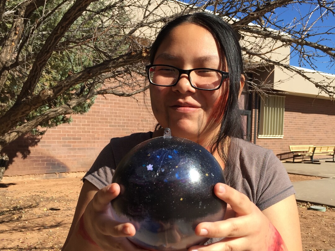 (Photo courtesy of Georgiana Simpson) A student at Whitehorse High School holds an ornament she painted.