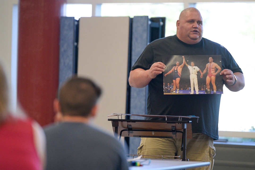 (Francisco Kjolseth  |  The Salt Lake Tribune)  Olympic wrestling champion Rulon Gardner displays a photo of his historic upset over Russian Aleksandr Karelin for the gold medal during the 2000 Sydney Olympics as he meets with students and parents on Wed. May 16, 2018, to introduce himself as the new wrestling coach at Herriman High school. 