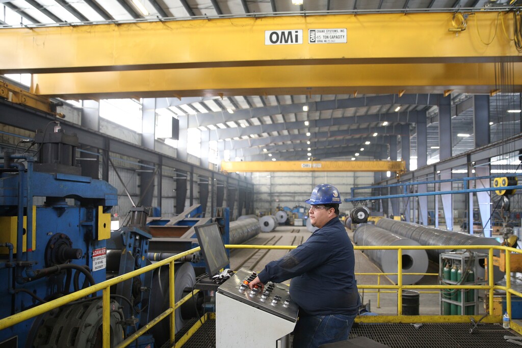 Ranulfo Flores operates machinery at the Borusan Mannesmann steel pipe plant in Baytown, Texas, Monday, April 23, 2018. President Donald Trump's escalating dispute with China over trade and technology is threatening jobs and profits in working-class communities where his "America First" agenda hit home. Without a waiver, Borusan Mannesmann Pipe may face tariffs of $25 million to $30 million annually if it imports steel tubing and casing from its parent company in Turkey, according to information the company provided to The Associated Press. (AP Photo/Loren Elliott)