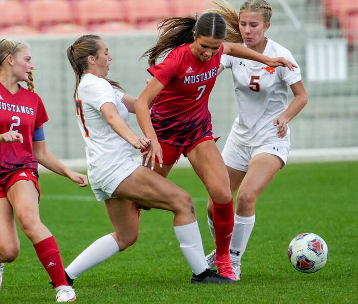 (Leah Hogsten | The Salt Lake Tribune) Mountain Crest's Sadie Coggins (17) and Ali Myers (5) pressure Crimson Cliffs' Kate Young during the 4A State Soccer Championship game between Mountain Crest High School and Crimson Cliffs High School, Oct. 22, 2021 at Rio Tinto Stadium. Mountain Crest defeated Crimson Cliffs 1-0 in double overtime.