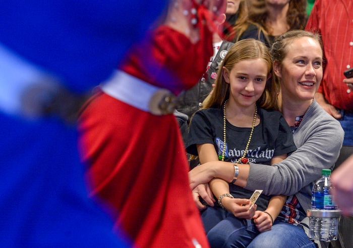 (Leah Hogsten | The Salt Lake Tribune) Reagan Jenkins cuddles with her mom, Brooke Walters on Saturday as the two watch a dance troupe before boarding their flight. Ten Gold Star families from Salt Lake City were treated to a Winter Wonderland scene, including Whoville and the Grinch at their boarding gate at Salt Lake International Airport, Dec. 7, 2019 before their flight to Disney World aboard the Snowball Express. This month, the Gary Sinise Foundation's Snowball Express will fly more than 1,700 family members of fallen U.S. military heroes to Disney World for a holiday retreat.