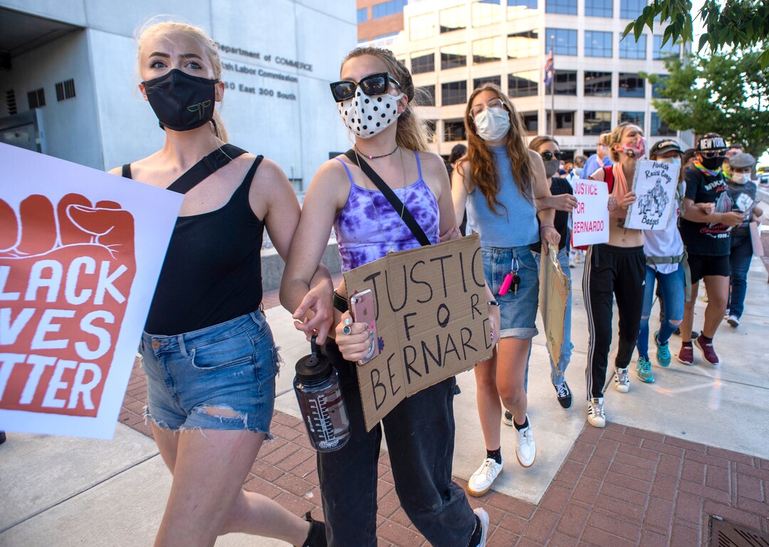 (Rick Egan  |  The Salt Lake Tribune) Protesters lock arms as they walk down the sidewalk followed by Salt Lake City Police during a Justice for Bernardo Palacios-Carbajal protest on Tuesday, June 23, 2020.