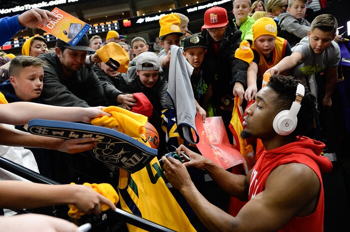 (Francisco Kjolseth  |  The Salt Lake Tribune)  Utah Jazz guard Donovan Mitchell (45) signs autographs for young fans before the Sacramento Kings NBA game at Vivint Smart Home Arena Wed., Nov. 21, 2018, in Salt Lake City.