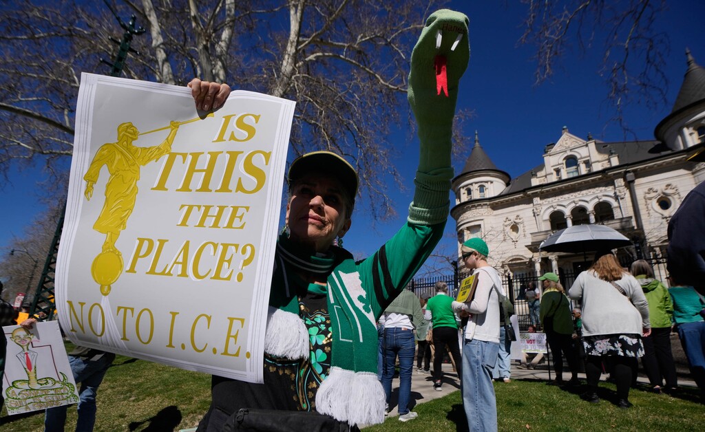 (Francisco Kjolseth  | The Salt Lake Tribune) Suzann Withers makes the point to “drive the snakes out” as she joins other protesters gathered outside the Governor’s Mansion in response to the recent purchase of a Salt Lake City warehouse by ICE on Tuesday, March 17, 2026.