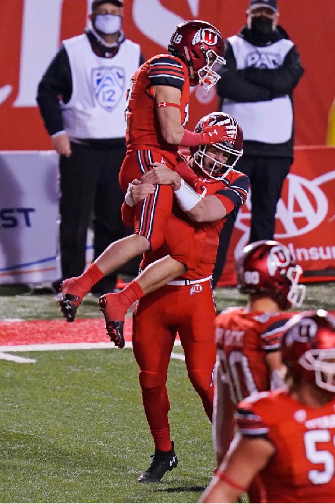 Utah wide receiver Britain Covey (18) jumps in to the arms of quarterback Jake Bentley (8) after he scored against Oregon State during the second half of an NCAA college football game Saturday, Dec. 5, 2020, in Salt Lake City. (AP Photo/Rick Bowmer)