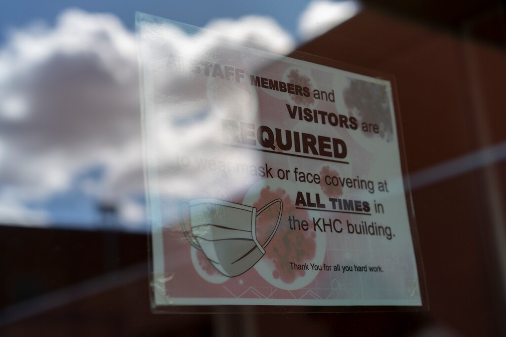 (Carolyn Kaster | AP file photo)  A sign on a door warns people to wear face coverings at the Kayenta Health Center on the Navajo reservation in Kayenta, Ariz., on April 18, 2020.