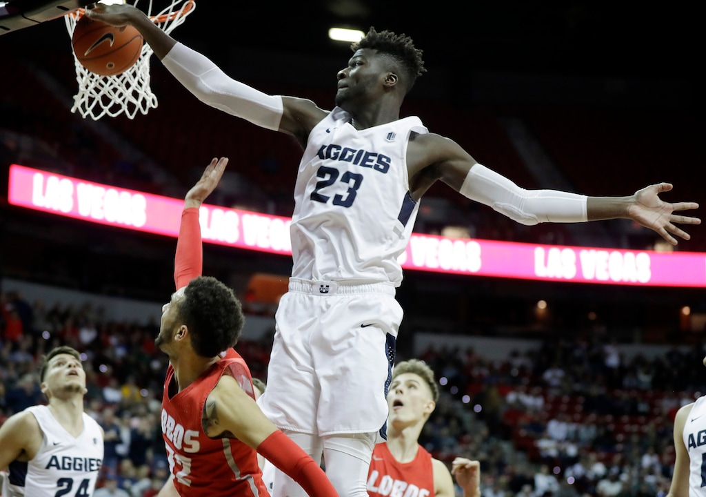 Utah State's Neemias Queta (23) blocks a shot from New Mexico's Anthony Mathis during the second half of an NCAA college basketball game in the Mountain West Conference men's tournament Thursday, March 14, 2019, in Las Vegas. (AP Photo/Isaac Brekken)