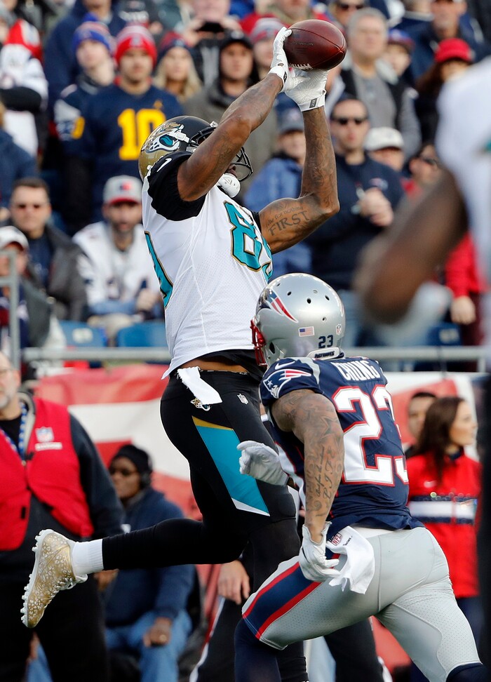 Jacksonville Jaguars tight end Marcedes Lewis (89) makes a touchdown catch against New England Patriots safety Patrick Chung (23) during the first half of the AFC championship NFL football game, Sunday, Jan. 21, 2018, in Foxborough, Mass. (AP Photo/Winslow Townson)