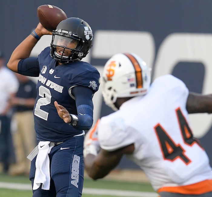 Utah State quarterback Kent Myers (2) throws a pass as Idaho State linebacker Christian Holland (44) defends during an NCAA college football game Thursday, Sept. 7, 2017, in Logan, Utah. (Eli Lucero/Herald Journal via AP)