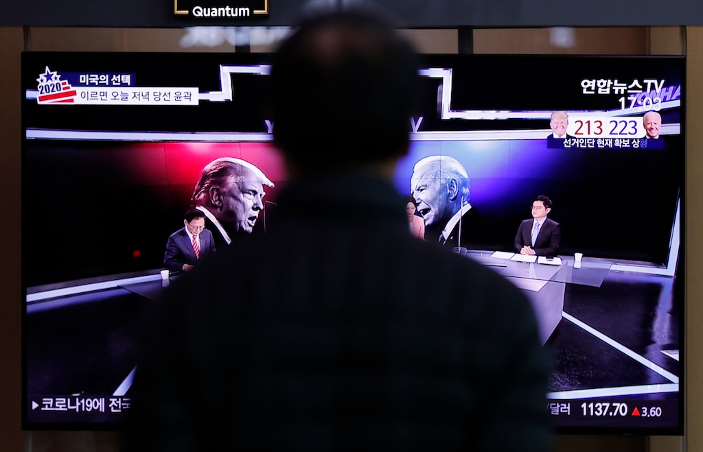 (Lee Jin-man | AP) A man watches a TV screen showing the images of U.S. President Donald Trump and Democratic presidential candidate former Vice President Joe Biden during a news program of the U.S. presidential election, at the Seoul Railway Station in Seoul, South Korea, Wednesday, Nov. 4, 2020.
