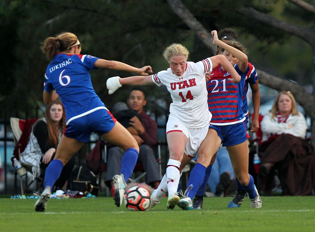 Utah soccer's  Paola van der Veen fights for control of the ball against two Kansas defenders in a game played on Sept. 15, 2017. Photo courtesy of Steve C. Wilson / University of Utah)