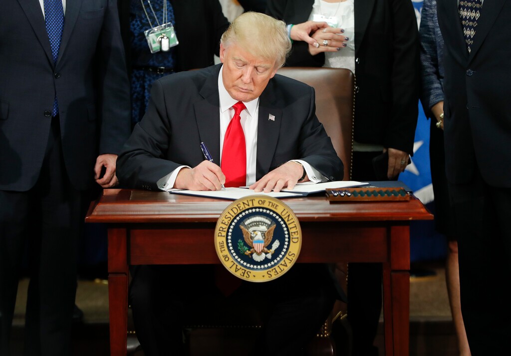 In this Jan. 25, 2017, photo, President Donald Trump signs an executive order for border security and immigration enforcement improvements at the Department of Homeland Security in Washington. Immigration to the United States has come in swells and dips over the past two-plus centuries, driven by shifts in U.S. policy, the mood in the country and world events.

 (AP Photo/Pablo Martinez Monsivais)