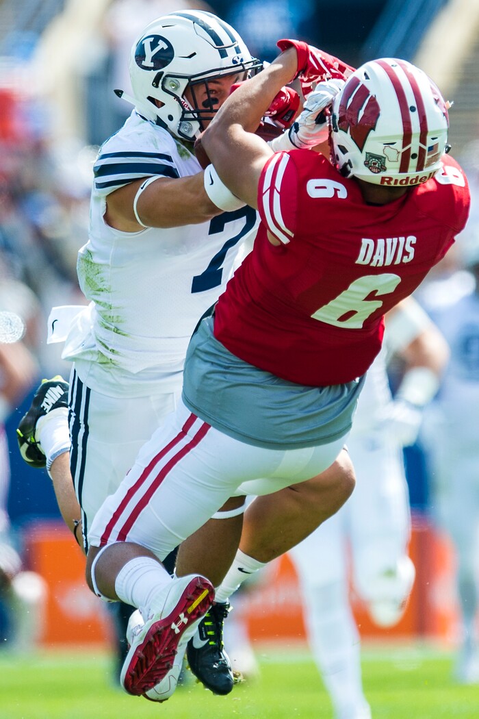 (Chris Detrick  |  The Salt Lake Tribune)   Wisconsin Badgers wide receiver Danny Davis III (6) makes a catch over Brigham Young Cougars defensive back Micah Hannemann (7) during the game at LaVell Edwards Stadium Saturday Saturday, September 16, 2017. Wisconsin Badgers are leading Brigham Young Cougars 24-6 at halftime.