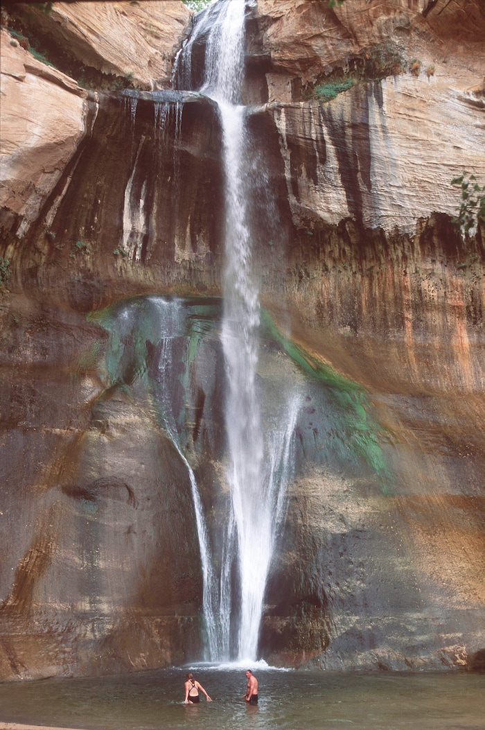 (Al Hartmann | Tribune file photo) Hikers cool off beneath Calf Creek Falls in Escalante National Monument in May, 2009.