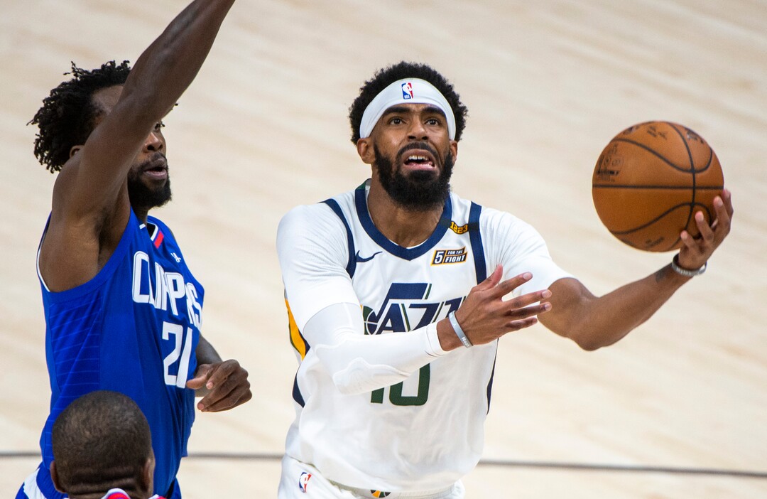 (Rick Egan | The Salt Lake Tribune) Utah Jazz guard Mike Conley (10) gets past LA Clippers guard Patrick Beverley (21) as he goes to the hoop, in NBA action between the Utah Jazz and the LA Clippers at Vivint Arena, on Friday, Jan. 1, 2021.