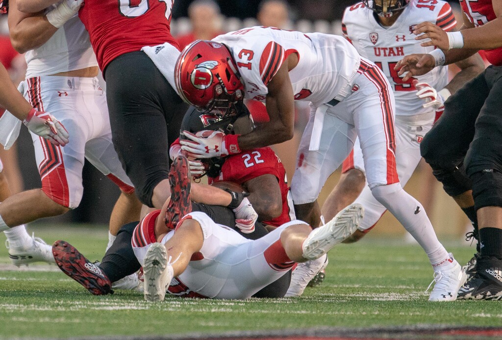 Utah Utes linebacker Cody Barton (30) and  defensive back Marquise Blair (13) hit NIU running back Tre Harbison (22) in the backfield for a loss during a college football game at Huskie Stadium in DeKalb, IL on Saturday, Sept. 08, 2018 (Sean King | for The Salt Lake Tribune)