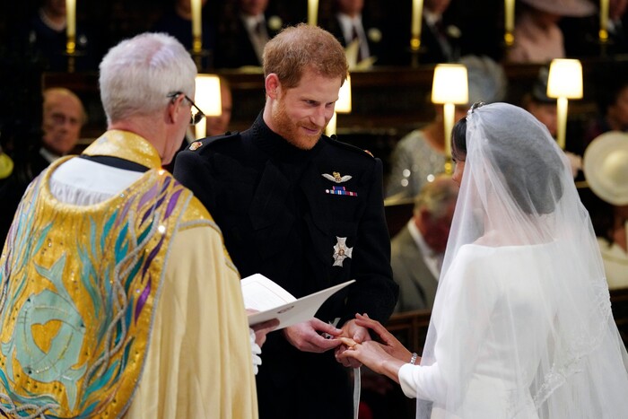 Britain's Prince Harry places the ring on Meghan Markle during their wedding ceremony at St. George's Chapel in Windsor Castle in Windsor, near London, England, Saturday, May 19, 2018. (Jonathan Brady/pool photo via AP)