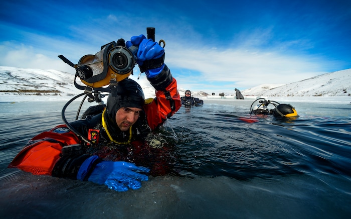 Leah Hogsten | The Salt Lake Tribune Riverside County Sheriff's Department dive member Devon Schmidt exits the water during training Wednesday to tend to his free-flowing mask that was leaking air. The Utah Department of Public Safety's Dive Team and the Riverside County Sheriff's Office joined forces for a day of ice diving at Deer Creek Reservoir, Feb. 20, 2019. Twenty members from Riverside County Sheriff's Department dove in icy waters alongside DPS' 10 man team in a joint team training day, Wednesday. Members of the Riverside County Sheriff's were working to become certified in ice diving under the team's lieutenant and dive master. Due to the equipment assets and the unique diver skill sets, dive teams are often called upon to provide assistance to aquatic homicide investigations and accidental drownings.