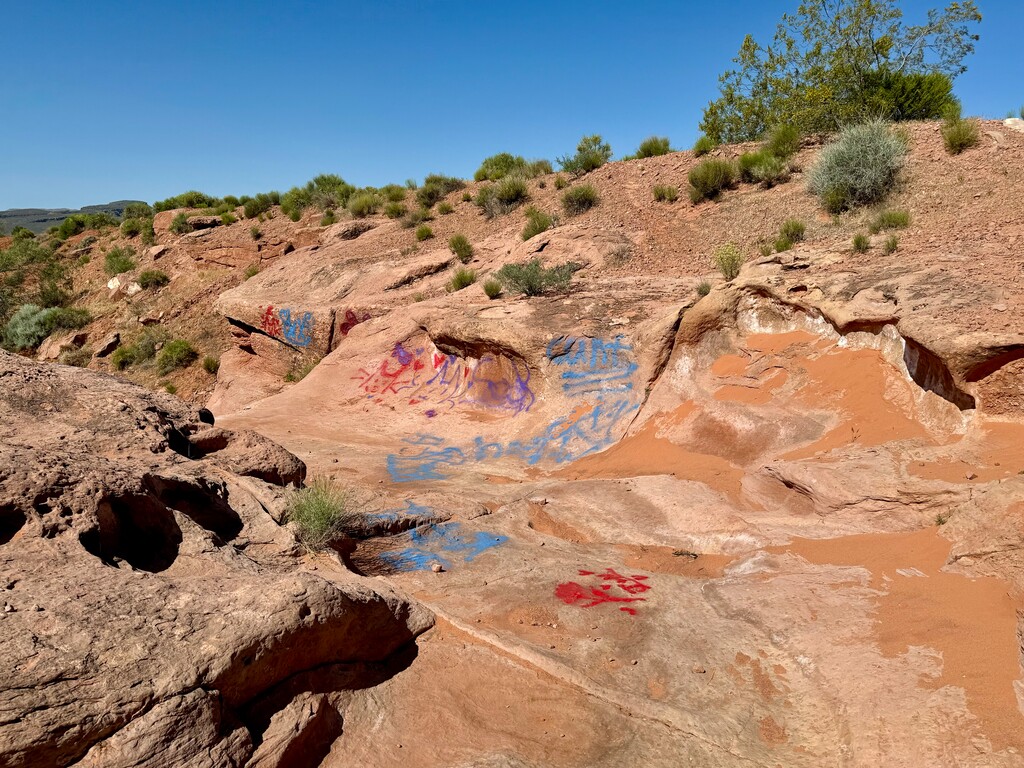 (Mark Eddington | The Salt Lake Tribune) Graffiti is seen along a trail at Rainbow Canyon in Ivins, Monday, May 6, 2024.
