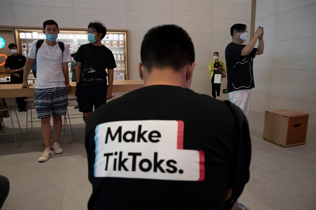 (Ng Han Guan | The Associated Press) A man wearing a shirt promoting TikTok is seen at an Apple store in Beijing on Friday, July 17, 2020. U. S. President Donald Trump says he wants to take action to ban TikTok, a popular Chinese-owned video app that has been a source of national security and censorship concerns.