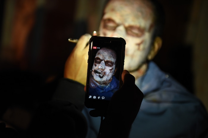 (Francisco Kjolseth  |  The Salt Lake Tribune)  Utah House Speaker Greg Hughes falls prey to the zombie apocalypse with the help of makeup artist Becky Manuel at the Fear Factory on Thursday, Oct. 12, 2017, for a special event to raise awareness of the Utah Food Bank and kick start donations. 