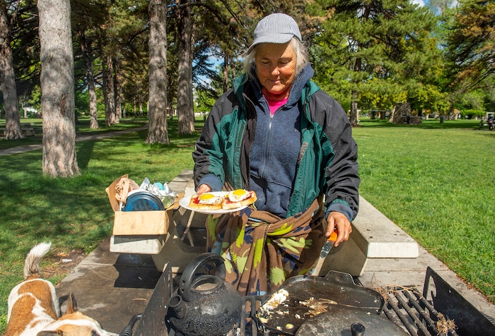 (Rick Egan  |  The Salt Lake Tribune)     Rosie Webster cooks some eggs and toast at Liberty Park, Saturday, May 23, 2020.