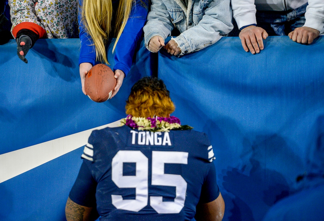 Leah Hogsten  |  The Salt Lake Tribune  Brigham Young Cougars defensive lineman Khyiris Tonga (95) signs autographs for fans after BYU defeated Hawaii 49-23 at Lavell Edwards Stadium in Provo, Saturday Oct. 13, 2018. 