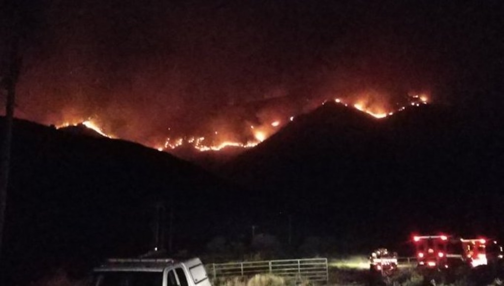 (Photo courtesy of Utah Fire Info) The Goose Point Fire, seen here looking west from Spanish Fork, is burning on West Mountain in Utah County.